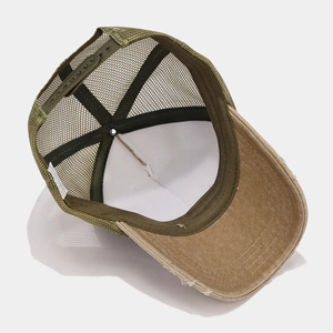Detail of washed trucker hat showing mesh back, inner sweatband, and adjustable snapback