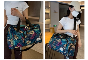 Detail view of large capacity travel tote bag with blue leaf print and adjustable strap