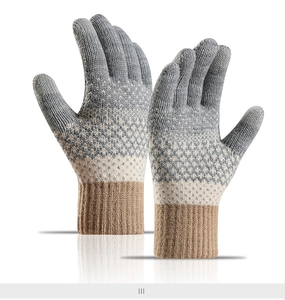 Macro detail of winter knit gloves featuring argyle patterns and ribbed brown cuffs