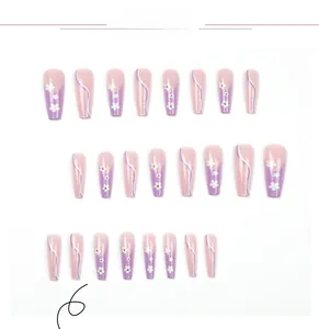 Detail of purple long ballerina press-on nails with white flower patterns and golden dots