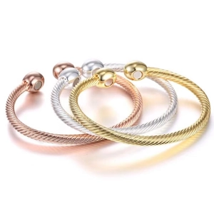 Three twisted wire steel cuff bracelets in rose gold, silver and gold tones with magnetic ends