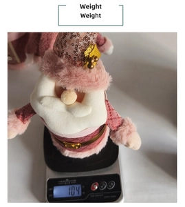 Detail shot showing a pink Santa plush doll weighing 104g on a digital scale