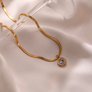 18K gold plated butterfly pendant necklace on white silk fabric with round crystal