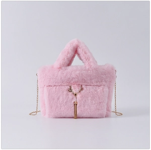 Detailed view of pink faux fur handbag with gold reindeer ornament and tassel fringe