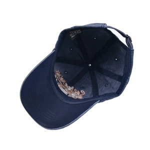 Inside view of navy blue washed cotton baseball cap with 100% cotton label and stitching