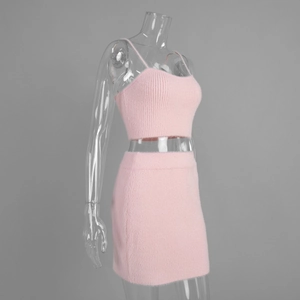Close-up of pink fuzzy knit fabric on a two-piece crop top and mini skirt set