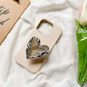Cream beige leather phone case with silver liquid metal heart mirror stand on soft fabric