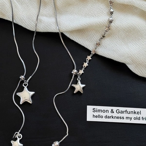Chic silver asymmetric star pendant necklace with snake chain for a modern minimalist look