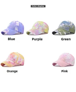 Detail of colorful tie-dye baseball caps with sequined bear patterns in five vibrant colors