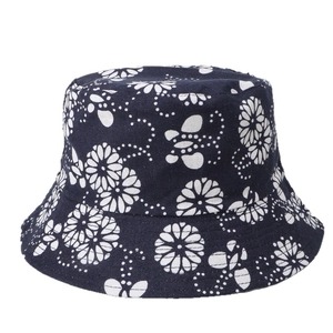 Double-sided cotton bucket hat with white daisy floral print and navy blue canvas texture