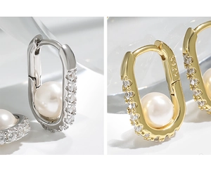 Detail of S925 sterling silver stamp on oval pearl earrings with zircon stones