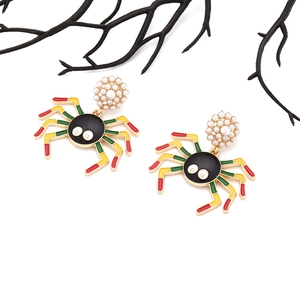 Detail showing enamel spider earrings with faux pearl studs and colorful legs