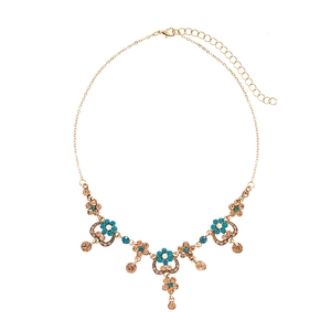 Vintage gold necklace with blue crystal flower heart pendant on white background