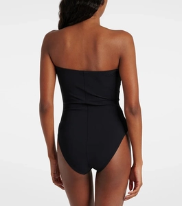Detail view of backless black one-piece swimsuit with snug ergonomic fit and matte fabric