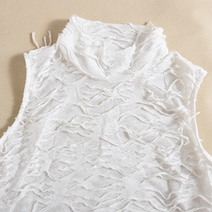 Detail view of the white sleeveless maxi dress with unique frayed and hollowed-out texture