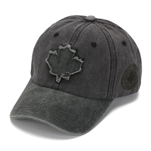 Detailed macro of a dark charcoal washed cotton baseball cap with maple leaf embroidery