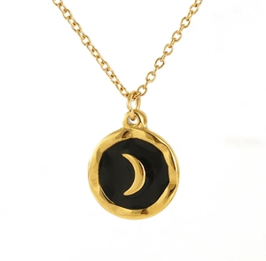 Macro detail of gold coin necklace with black enamel inlay and crescent moon pattern