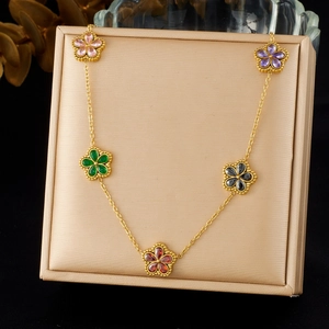 Gold stainless steel flower necklace with five colorful crystal petal pendants on tray