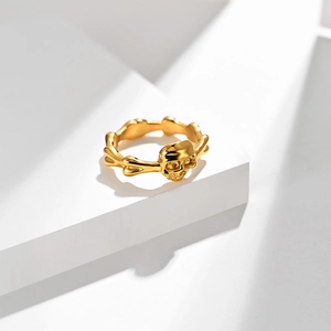 Golden punk rock skull ring with bone band design on white geometric background