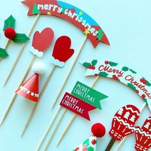 Detailed set of Christmas cake toppers featuring Merry Christmas banners and red mittens