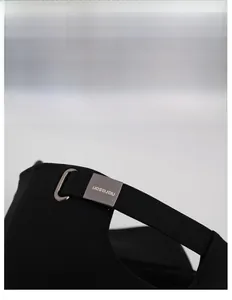 Detail of adjustable metal buckle with brand logo on black cotton baseball cap