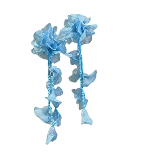 Blue chiffon flower tassel earrings with silver needles and beads on white background