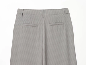 Close-up of gray pinstripe trousers back featuring welt pockets and belt loops detail