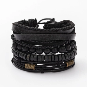 Close-up of black multilayer leather bracelet set with woven ropes and matte beads