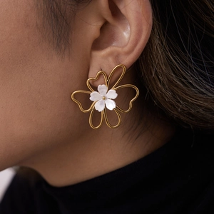 Detail view of 18K gold plated stainless steel flower earrings with opal petal accents