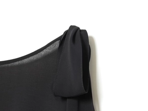 Detail view of black georgette fabric with delicate sheer texture and pleated sewing work