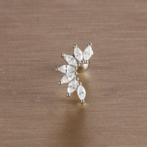 Macro shot of silver stainless steel leaf stud earrings with white marquise zircons