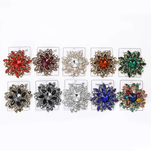 Detail view of assorted vintage flower brooches with colorful rhinestones on cards
