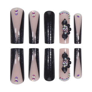 French V-cut press-on nails in black glitter with 3D floral accents and rhinestones