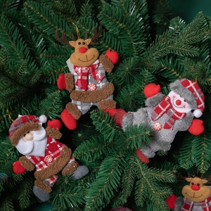 Three-piece Christmas ornaments set with Santa, Snowman, and Reindeer hanging on a green tree
