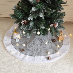 Grey plush Christmas tree skirt with white faux fur trim and festive gold embossed text