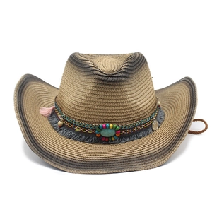 Western straw cowboy hat with bohemian beads, turquoise, and feathers on white background