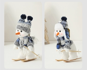 Detail of blue and white knitted plush snowmen with wooden skis and poles for Xmas décor