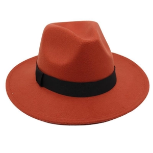 Close-up of rust red felt fedora hat featuring a classic black ribbed ribbon band detail