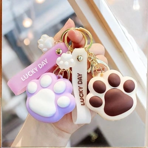 Cute cartoon cat paw keychains in purple and brown with Lucky Day strap charms