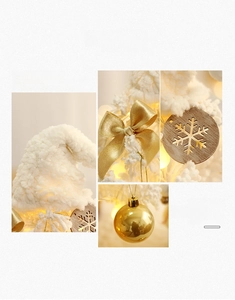 Detail of white flocked ornaments with wooden snowflake and gold bow for Christmas tree