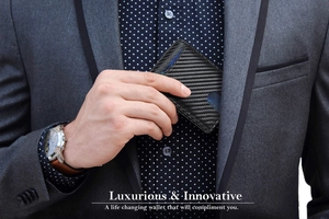 Business man taking a slim carbon fiber RFID wallet out of a gray suit pocket