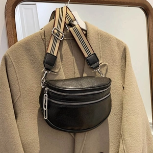 Fashionable black pebble leather crossbody waist bag with wide striped canvas shoulder strap