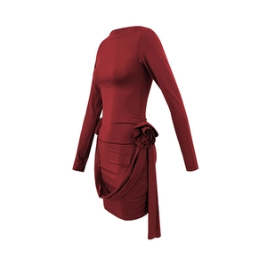 Detailed view of red long sleeve dress featuring a 3D floral accent and draped ribbons