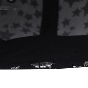 Detail of metal star print on black cotton baseball cap with mesh fabric texture