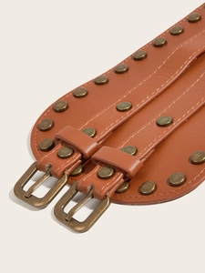 Close-up of brown textured leather wide belt featuring retro metal rivets and buckles