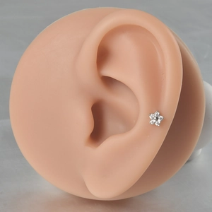 Detail of silver G23 titanium flower cartilage stud with clear zircons on ear model