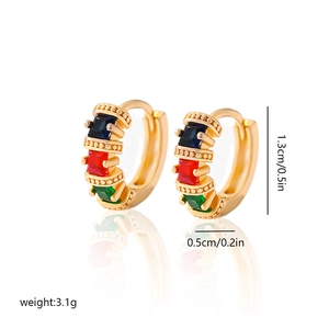 Detail of gold hoop earrings with square-cut blue red and green gemstones