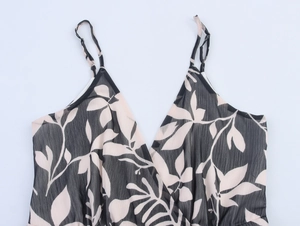 Close-up of V-neckline and spaghetti straps on a black chiffon floral dress for summer