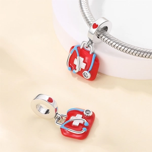 Silver medical first aid kit charm with red enamel, stethoscope design and zircon stone
