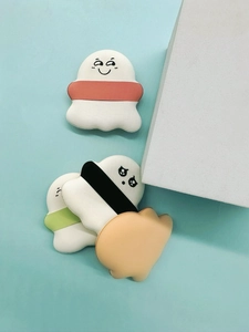 Macro view of cute marshmallow air cushion powder puffs with various cartoon expressions
